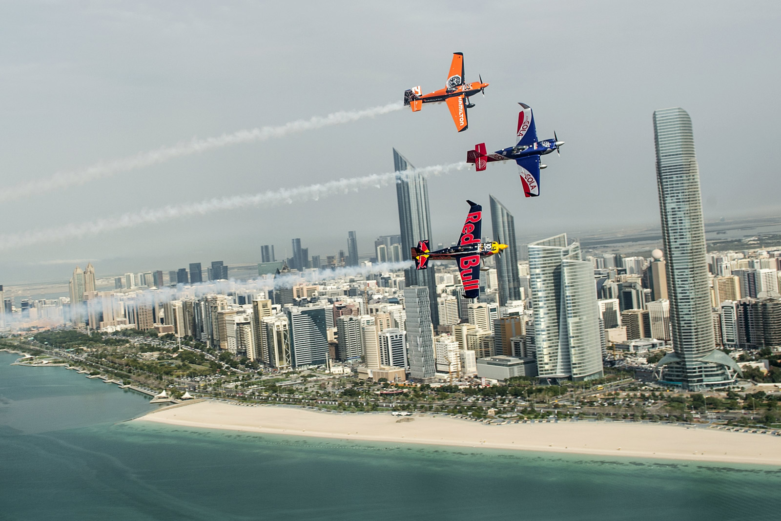 Matt Hall of Australia leads Kirby Chambliss of the United States and Nicolas Ivanoff of France over the Emirates Palace prior to the first stage of the Red Bull Air Race World Championship in the city of Abu Dhabi in the United Arab Emirates on March 8, 2016. // Joerg Mitter / Red Bull Content Pool // P-20160308-00388 // Usage for editorial use only // Please go to www.redbullcontentpool.com for further information. //